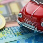 A red car on Euro banknotes