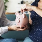 Family saving money in piggy bank