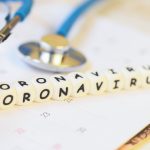 Coronavirus words and stethoscope on calendar – COVID-19 coronavirus spread influenza medical crisis pandemic public health risk prevention