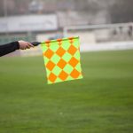 Soccer referee hold the flag. Offside trap