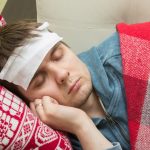Man with fever sleeping on the sofa