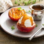 Grilled peaches with ice cream and caramel sauce, summer dessert