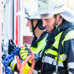 Fire fighter checking the hoses at fire engine
